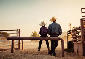 Man and son with cowboy hats