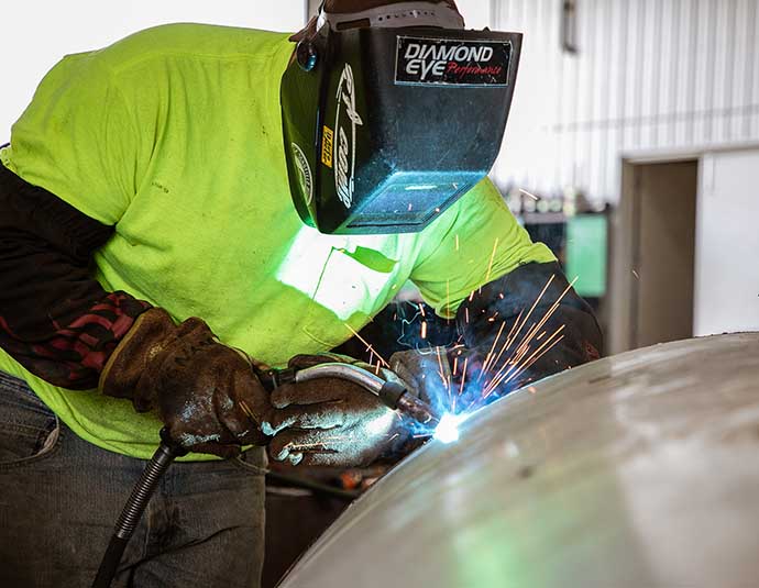 a farmer welding equipment